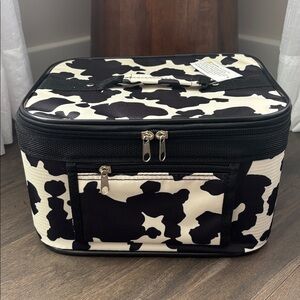 Cow  print zip close,interior mirror,brush slots, handle & strap,zip pocket